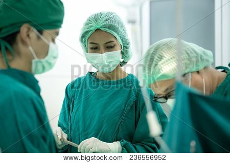 The Surgery Team Working Together At The Operating Room In The Hospital.