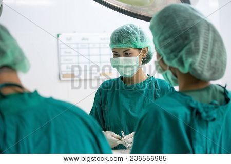 The Surgery Team Working Together At The Operating Room In The Hospital.