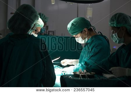 The Surgery Team Working Together At The Operating Room In The Hospital.