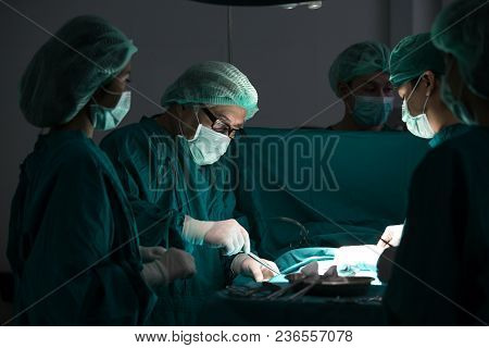 The Surgery Team Working Together At The Operating Room In The Hospital.