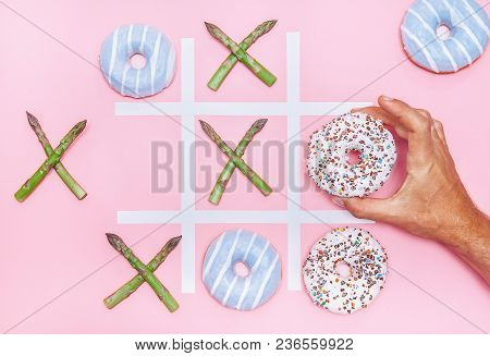 Playing In Tik Tak Toe Game With Donuts And Asparagus. Health Nutrition Concept Image