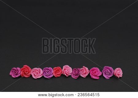 Mix Of Pink And Peach Fake Plastic Mini Rosess Flowers Black Background Copy Space. Craft, Art, Hobb