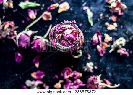Close Up Of Extracted Rose Water Or Gulab Jal Or Gulab Ka Pani In A Transparent Bottle On Black Surf
