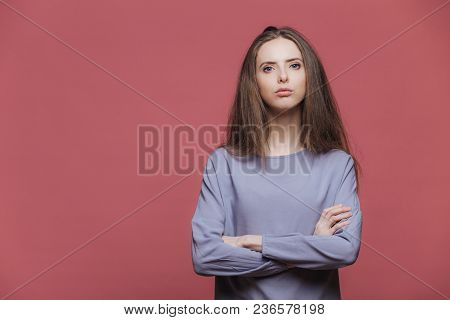 Portrait Of Serious Businesswoman Being Sure In Herself, Keeps Arms Folded, Wears Casual Sweater, Ha