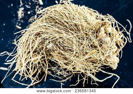 Ayurvedic Herb Vetiver Grass Or Khus On A Black Wooden Surface Used As A Flavoring Agent In Most Of