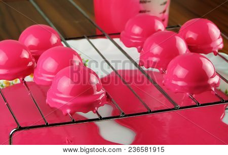 Raspberry Mousse Dessert, Coated Mirror Glaze On A Shiny Grill, During Cooking