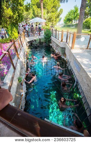 Pammukale, Turkey- July, 2015: Tourists swim in antique Cleopatra pool. Color of water is caused by the presence of a large amount of radon.