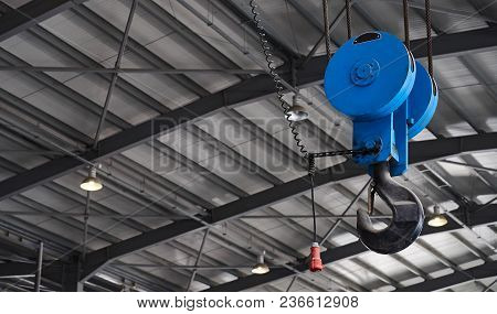 Crane Hook For Overhead Crane In Hangar Warehouse Of Factory, Close-up. Industry Manufacturing Conce