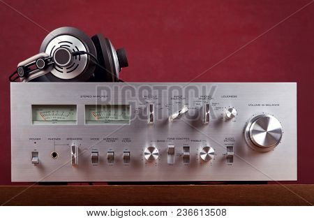 Vintage Stereo Amplifier Frontal Panel with VU meters Dark Background Closeup 