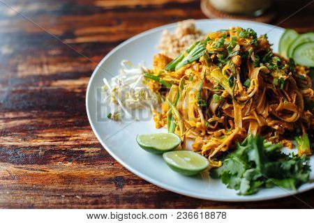 Close Up Padthai Noodle With Smoke Tofu And Mixed Vegetable - Wheat Germs,lime,cucumber,parsley On W