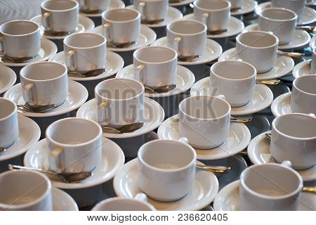 Set Of Empty White Ceramic Tea Or Coffee Cup And Saucers, Top View. Group Of Empty Cups Stacked In R