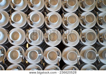 Set Of Empty White Ceramic Tea Or Coffee Cup And Saucers, Top View. Group Of Empty Cups Stacked In R