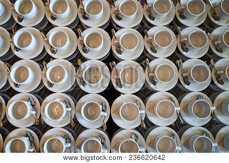 Set Of Empty White Ceramic Tea Or Coffee Cup And Saucers, Top View. Group Of Empty Cups Stacked In R