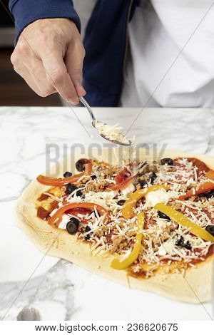 Man Pointing At Homemade Pizza Before Baking In The Oven