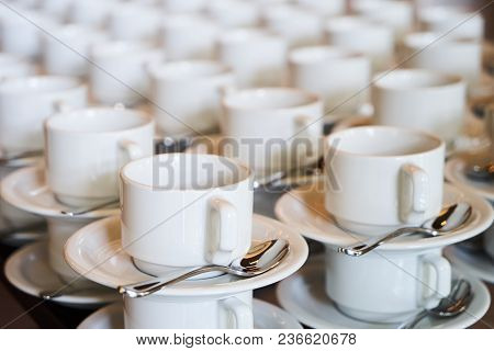 Set Of Empty White Ceramic Tea Or Coffee Cup And Saucers, Top View. Group Of Empty Cups Stacked In R