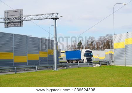 The Road Is Protected Against Noise Emission By Noise-absorbing Barrier (also Called A Soundwall, No
