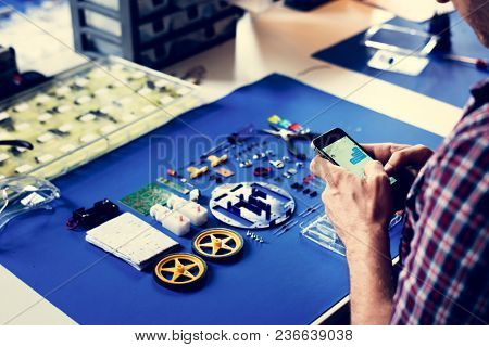Tecnician hands texting message with robot tools on blue background