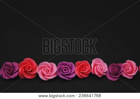 Mix Of Pink And Peach Fake Plastic Mini Rosess Flowers Black Background Copy Space. Craft, Art, Hobb
