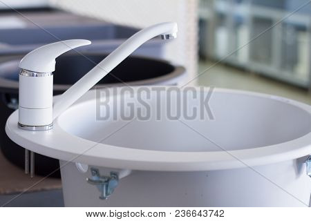 Modern Kitchen And Bathroom Water Faucets In The Store. Selective Focus. There Is Free Space For Tex