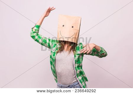 Happy Unknown Woman With A Paper Bag On Her Head On White Background.