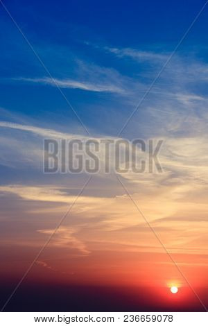 Natural Sunset Sunrise Over Field Or Meadow. Bright Dramatic Sky And Dark Ground. Countryside Landsc