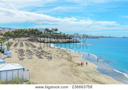 Beautiful Coastal View Of  El Duque Beach With Warm Turquoise Water And Gold Sand In Costa Adeje, Te