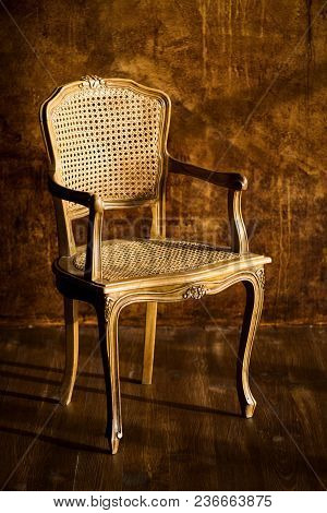 Old Chair On A Brown Wall Background
