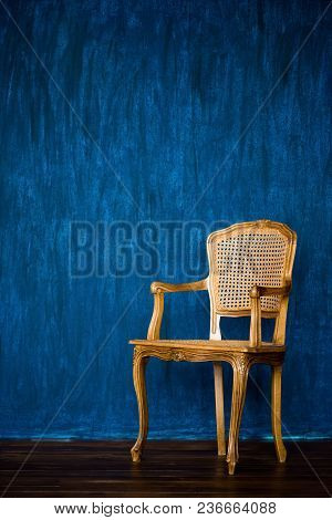 Old Chair On A Blue Wall Background