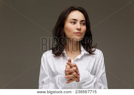Beautiful Girl In A White Shirt Shows Emotions. On A Light Background.