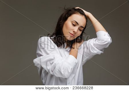 Beautiful Girl In A White Shirt Shows Emotions. On A Light Background.