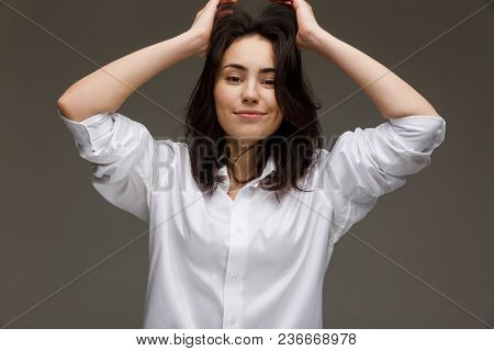 Beautiful Girl In A White Shirt Shows Emotions. On A Light Background.