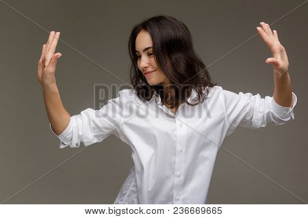 Beautiful Girl In A White Shirt Shows Emotions - Smile, Fun. On A Light Background.