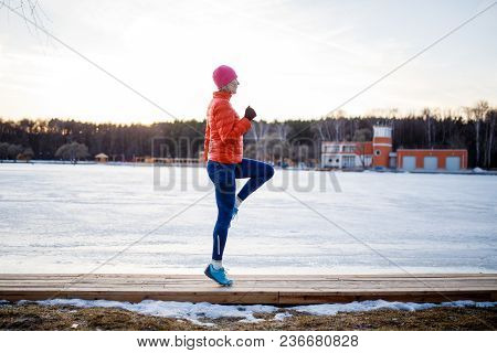 Potrtait Of Young Athlete Blonde At Morning Exercises In Winter Park