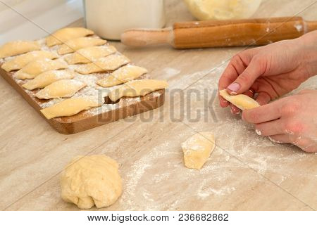 Douhg Preparation For Cooking Dumplings. Womens Hand Cutting Up Dough. Womens Hands In A Process Of 