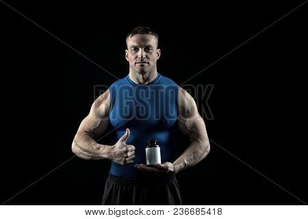 Food And Diet For Sport And Fitness. Sportsman With Vitamin Bottle Show Thumbs Up. Nutrition Supplem