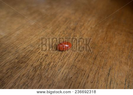Capsule Of Lutein Dietary Supplement On Wood