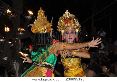 Ubud, Bali, Indonesia, July 2017 Two Women Dancing To Celebrated Kecak Fire Dance Performance.