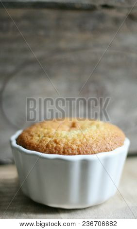 Tasty Cake In A Bolw In Front Of A Wood