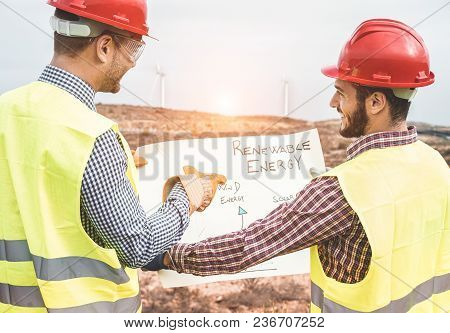 Workers Engineers Discussing Renewable Energy Project - Builders Planning How To Build A New Wind Fa