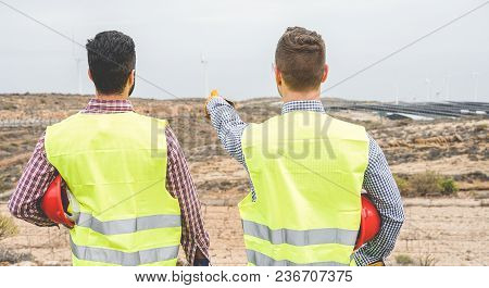 Builders Pointing New Area For Building  Wind Farm And Photovoltaic Plant Site - Happy Workers Plann