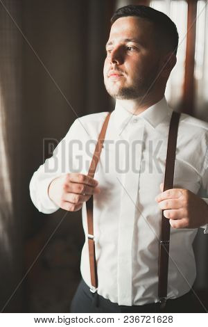 Grooms Morning Preparation. Handsome Man Getting Dressed And Preparing For The Wedding.