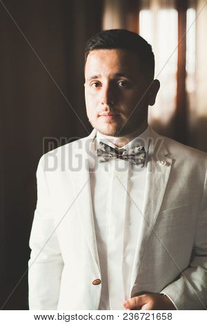 Grooms Morning Preparation. Handsome Man Getting Dressed And Preparing For The Wedding.