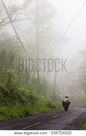 Motorcycle on foggy road. Bali, Indonesia