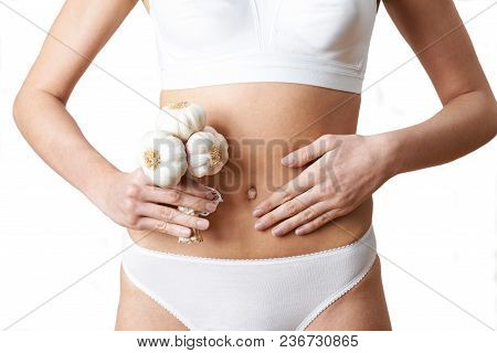 Close Up Of Woman In Underwear Holding Bunch Of Garlic