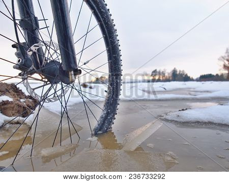 Bike Drowned In Muddy Pool Within Winter Trip. Broken Pieces Of Ice Around Freeze Terain Tyre, Wide 