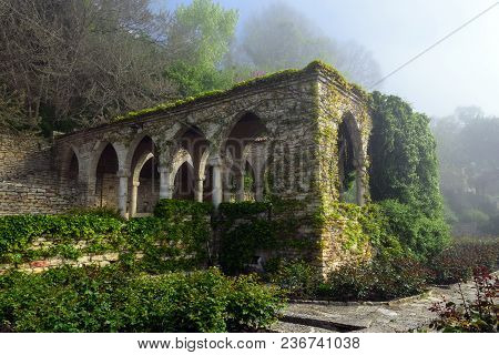 Old Stone Building And A Gazebo In The Forest.