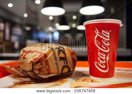 Minsk, Belarus, March 27, 2018: Sandwich With Kfc Logo And Paper Cup With Coca-cola Logo On Table In