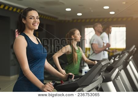 People Run On Treadmills. Men And Women Cardio Workout In Fitness Club. Healthy Lifestyle, Training 