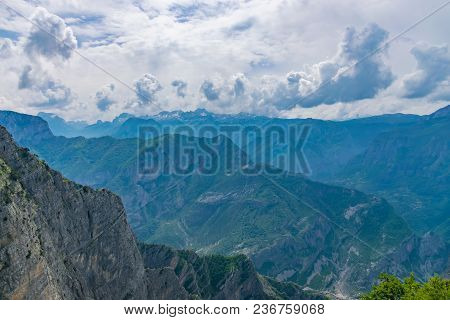 The Tops Of The Picturesque Mountains Are Covered With White Snow.