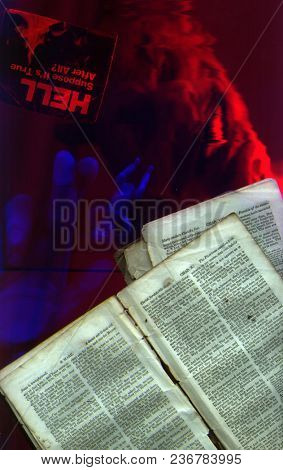 Pages from Bible. Demon face, doll and human hand. 3D rendering